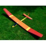 A kit built (For Radio Controlled) Glider Aircraft, comprising of 2 sections finished yellow/orange,