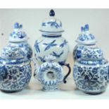 A pair of reproduction blue and white ginger jars and covers; together with a pair of blue and white