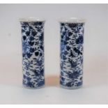 A pair of Chinese export blue and white cylindrical vases, each depicting birds amidst flowers and