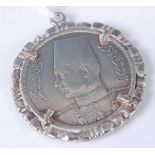 An Iznik white metal coin in pendant mount, 19.8g, 39mm