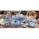 A large collection of blue and white transfer decorated dinner wares, mainly in the Willow
