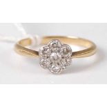 A Vintage ladies 18ct gold diamond flower head cluster ring, with 7 small pave set round cuts, 2.1g,