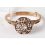 A mid century 18ct gold diamond cluster ring, arranged as 9 old cut diamonds in a flower head