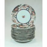 A set of 12 Japanese plates of shaped circular form decorated in the Imari palette in shades of iron
