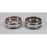 A pair of modern silver coasters with turned wooden bases, dia. 9cm