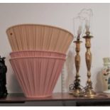 A pair of large turned brass table lamps each with pink pleated silk shade, height of lamps 70cm (