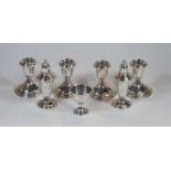 Two pairs of modern sterling silver dwarf table candlesticks, each on a loaded base, by Shreve Crump