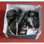 A box of various 35mm SLR cameras, to include Canon, together with a telephoto and other lenses,