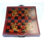 A modern Chinese travelling chess set, having a lacquered case containing resin chess pieces