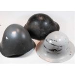 A WW II steel Brodie helmet, later grey painted, further red painted to the interior having a