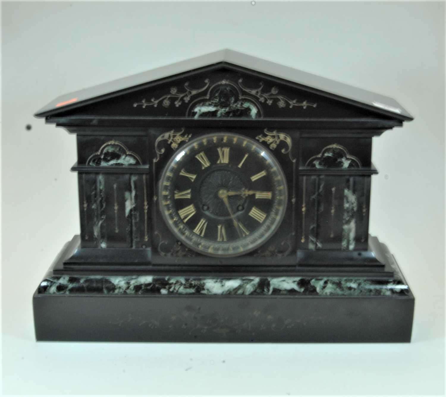 A large late 19th century black slate and veined marble cased mantel clock of architectural form,