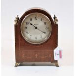 A 1920s mahogany cased and chequer strung mantel clock, having a convex silvered dial with Arabic