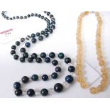 A beaded hardstone and faceted crystal long necklace 91cm, together with a carved and beaded