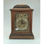 A late 19th century Winterhalder & Hofmeier oak cased bracket clock, having an arched brass dial