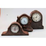 An Edwardian mahogany and satinwood inlaid cased mantel clock of shaped form having a convex