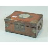 A Chinese hardwood and brass mounted work box, the hinged lid with central circular faux jade