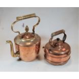 An early 20th century copper range kettle having brass spout and handle, the cover with acorn