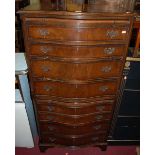 A reproduction mahogany serpentine front tallboy chest, having eight long drawers, with upper and