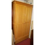 A contemporary light oak double door wardrobe having single long lower drawer, width 105cm