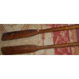 A pair of early 20th century mahogany rowing oars, each 270cm