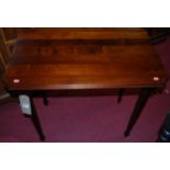 A walnut side table having canted corners and raised on turned tapering supports, width 85cm,