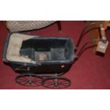 An early 20th century metal framed and canvas clad dolls pram, length 66cm