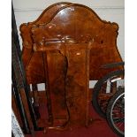 A pair of early 20th century figured walnut single beds, each with iron side rails