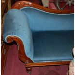 A mid-Victorian mahogany and upholstered showframe scroll-end settee, raised on turned supports to