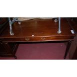 A mahogany single drawer writing table, raised on turned and fluted supports, w.130cm