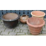 Two circular terracotta garden planters; together with an Eastern glazed example, and a terracotta