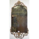 A 1930s arched and bevelled wall mirror having floral gilt surround, 83x44cm