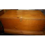 A stained pine hinge topped blanket box, having iron end carry handles, w.105cm