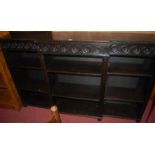 A circa 1900 ebonsied and relief carved oak breakfront open bookcase, w.182cmCondition report: