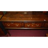 A 19th century oak and mahogany crossbanded three drawer dresser base, raised on moulded slightly