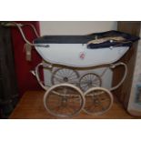 A mid 20th century white painted metal doll's pram