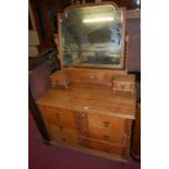 An early 20th century oak swing mirrorback three drawer dressing chest, w.99cm