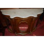 A mid-Victorian figured walnut, mirrored glass, and white marble top serpentine front three door