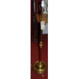 An early 20th century brass telescopic standard lamp raised on reeded circular base
