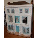 A painted three storey dolls house in the Georgian taste, having typical hinged opening, the