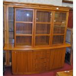 A Danish teak display cabinet, having three glazed upper doors enclosing adjustable glass shelves