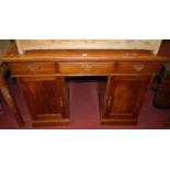 A late Victorian mahogany ledgeback twin pedestal sideboard, having three frieze drawers, the