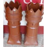 A pair of large brown glazed terracotta castle-top chimneys, h.91cm
