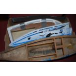 A part built fibre glass hull sailing boat, a part built fibre glass hull speedboat and a plastic