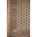 A Persian woollen pale ground Bokhara rug (with some losses and fading), 203x128cm