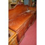 A mid-Victorian mahogany ledgeback sideboard, having three cushion frieze drawers over four