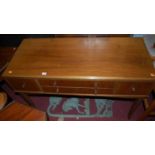 A 1930s walnut four drawer side table, raised on tapering supports, w.112cm