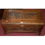 An Oriental stained and relief carved softwood hinged top small blanket box, width 71cm