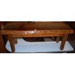 A rustic stained pine low bench, w.112.5cm