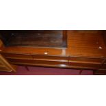 A 1970s teak low sideboard, fitted with four short drawers, raised on turned tapering supports, w.