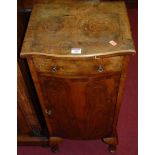 A 1930s figured walnut serpentine front single door bedside cupboard, having single upper drawer,